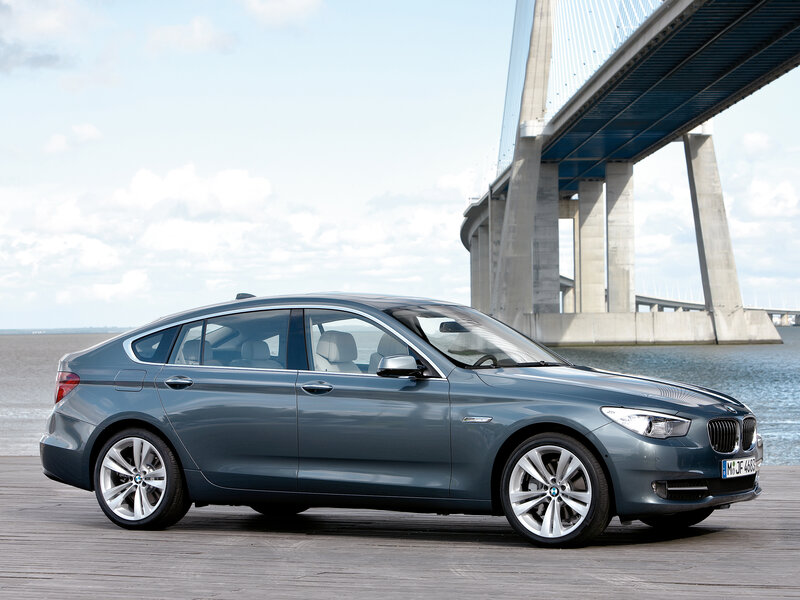 Blue BMW Gran Turismo by a bridge