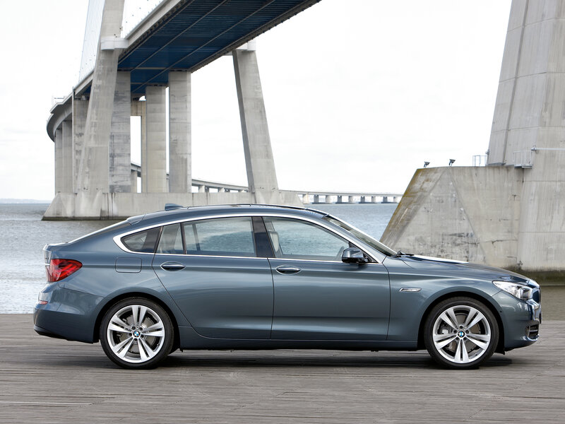 Blue BMW Gran Turismo by a bridge