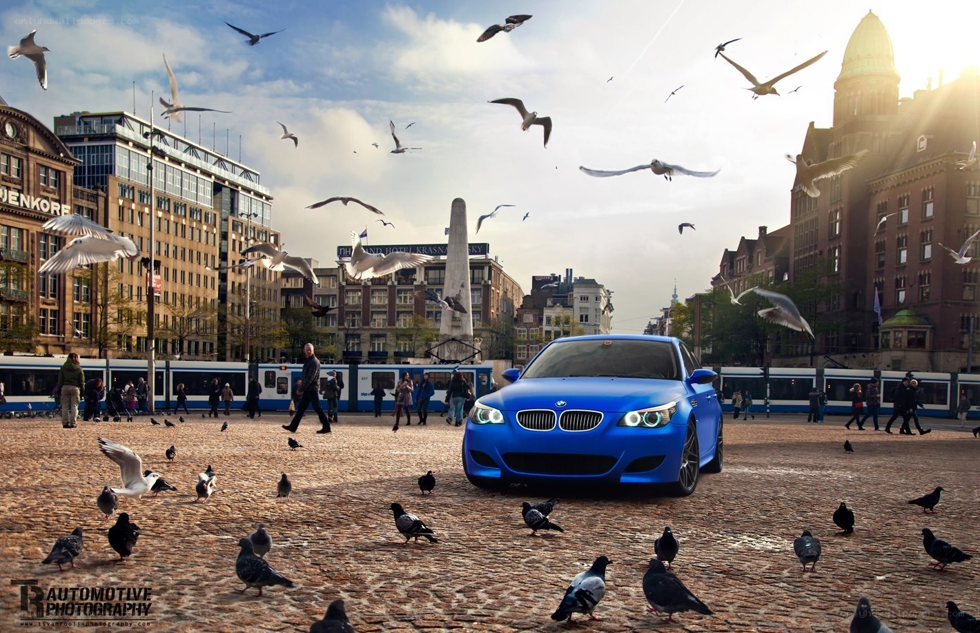 Blue BMW in a city square