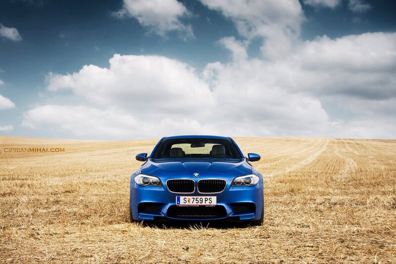Blue BMW in a field