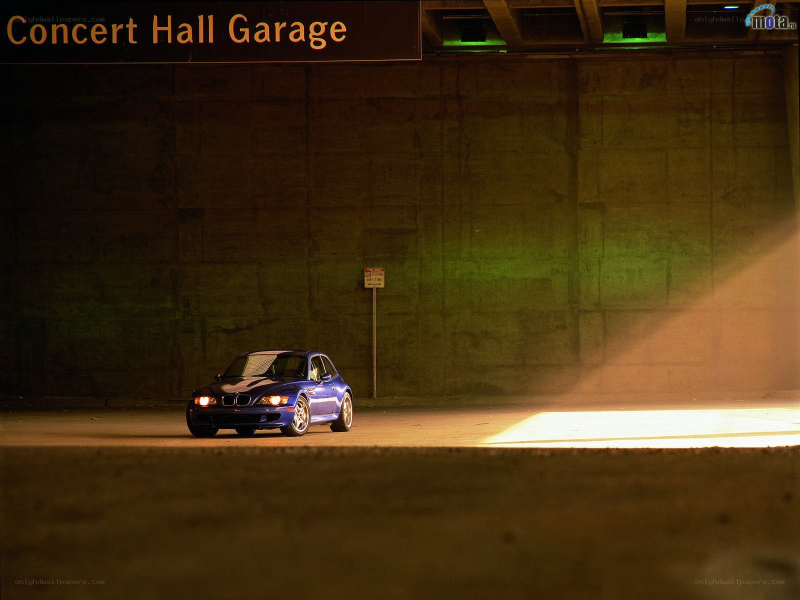 Blue BMW in a garage