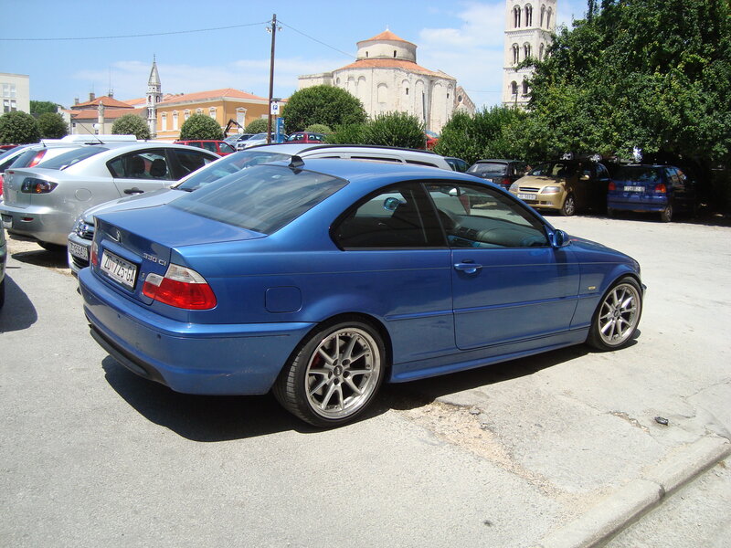 Blue BMW in a parking lot