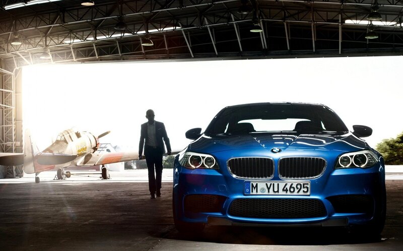 Blue BMW in an aircraft hangar