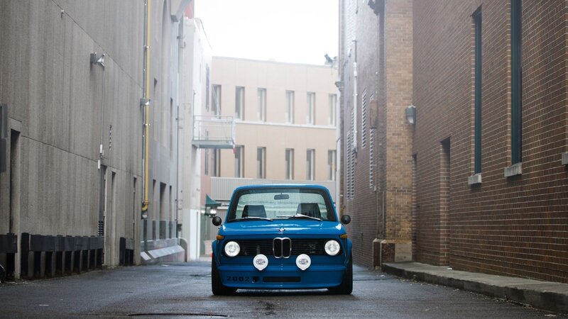 Blue BMW in an alley