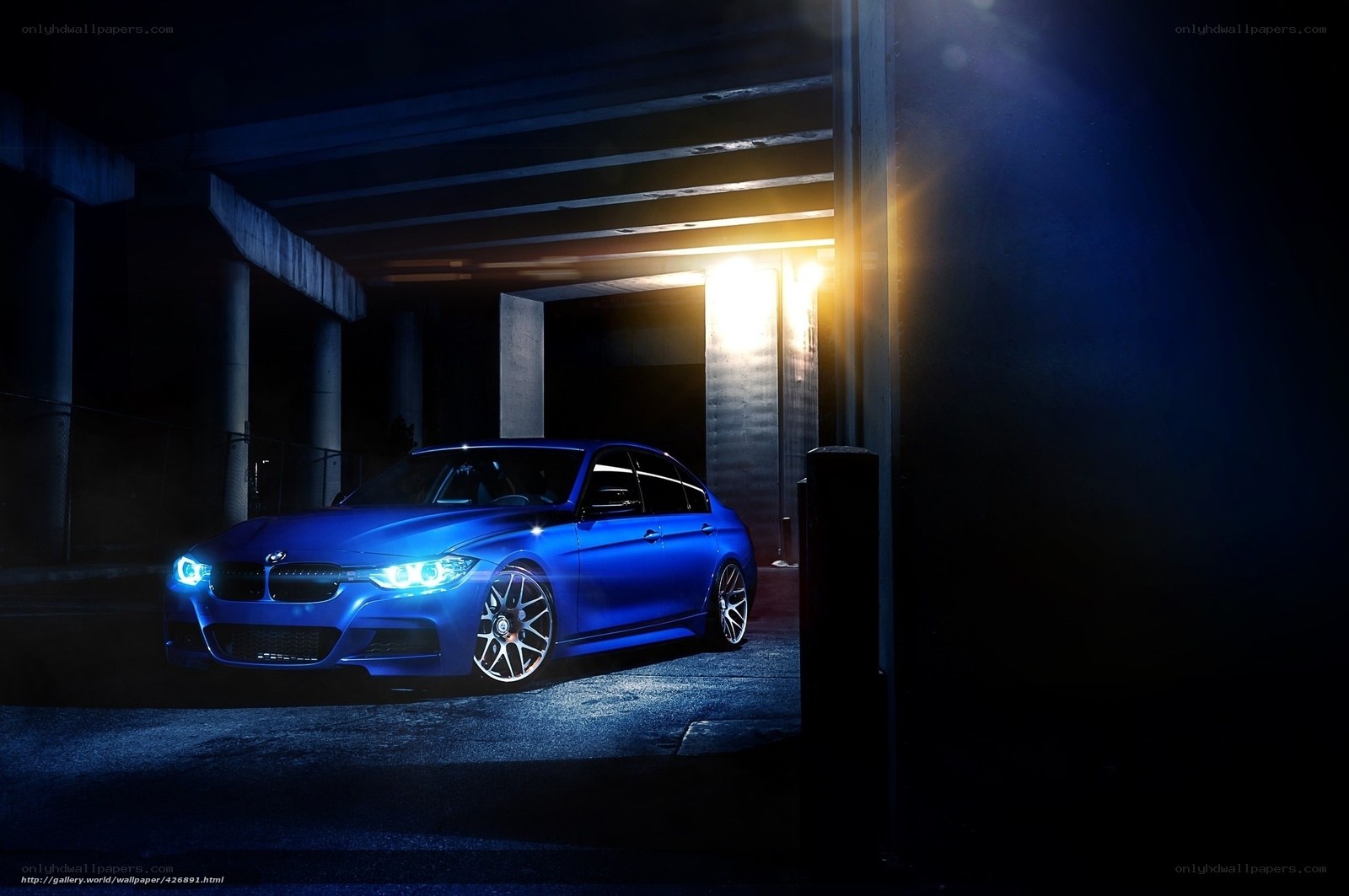 Blue BMW in dark garage
