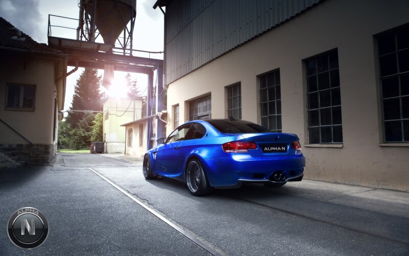 Blue BMW in industrial alley