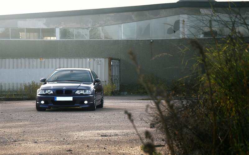 blue bmw in industrial area