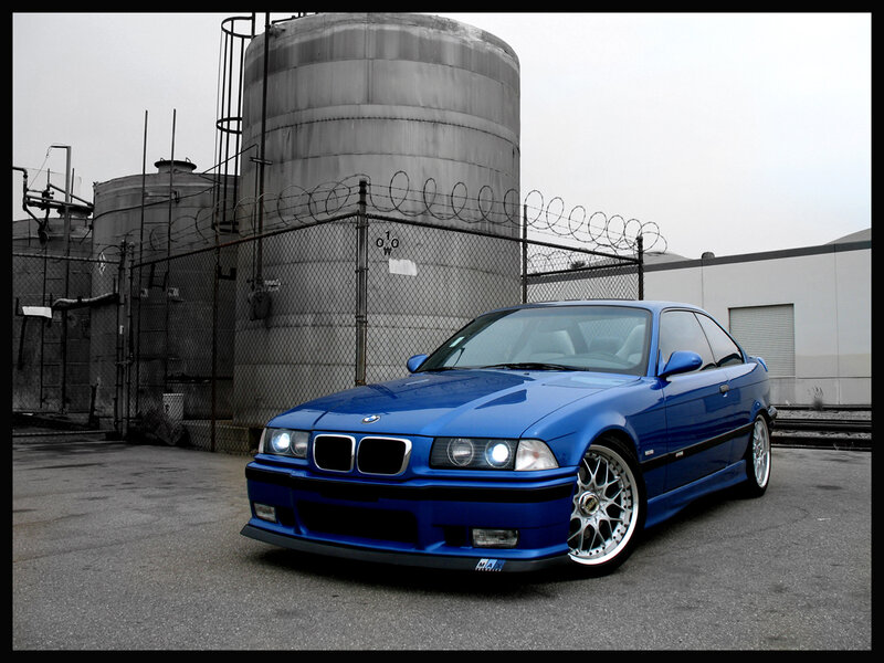 Blue BMW in industrial area