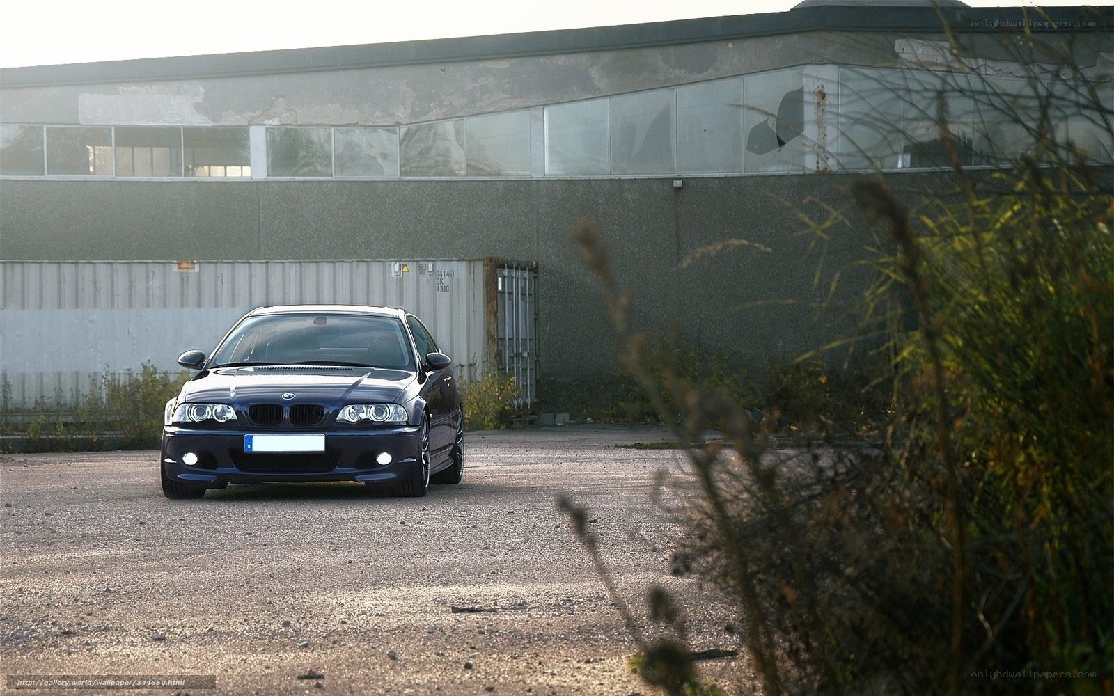 blue bmw in industrial lot