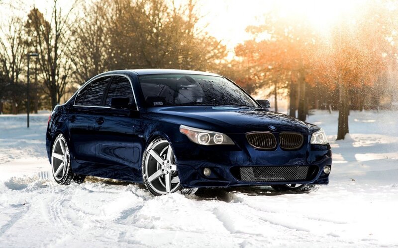 blue bmw in snowy landscape