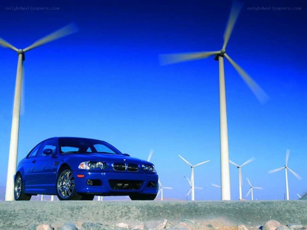Blue BMW in wind farm