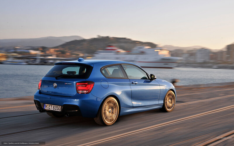 blue bmw m135i driving on pier