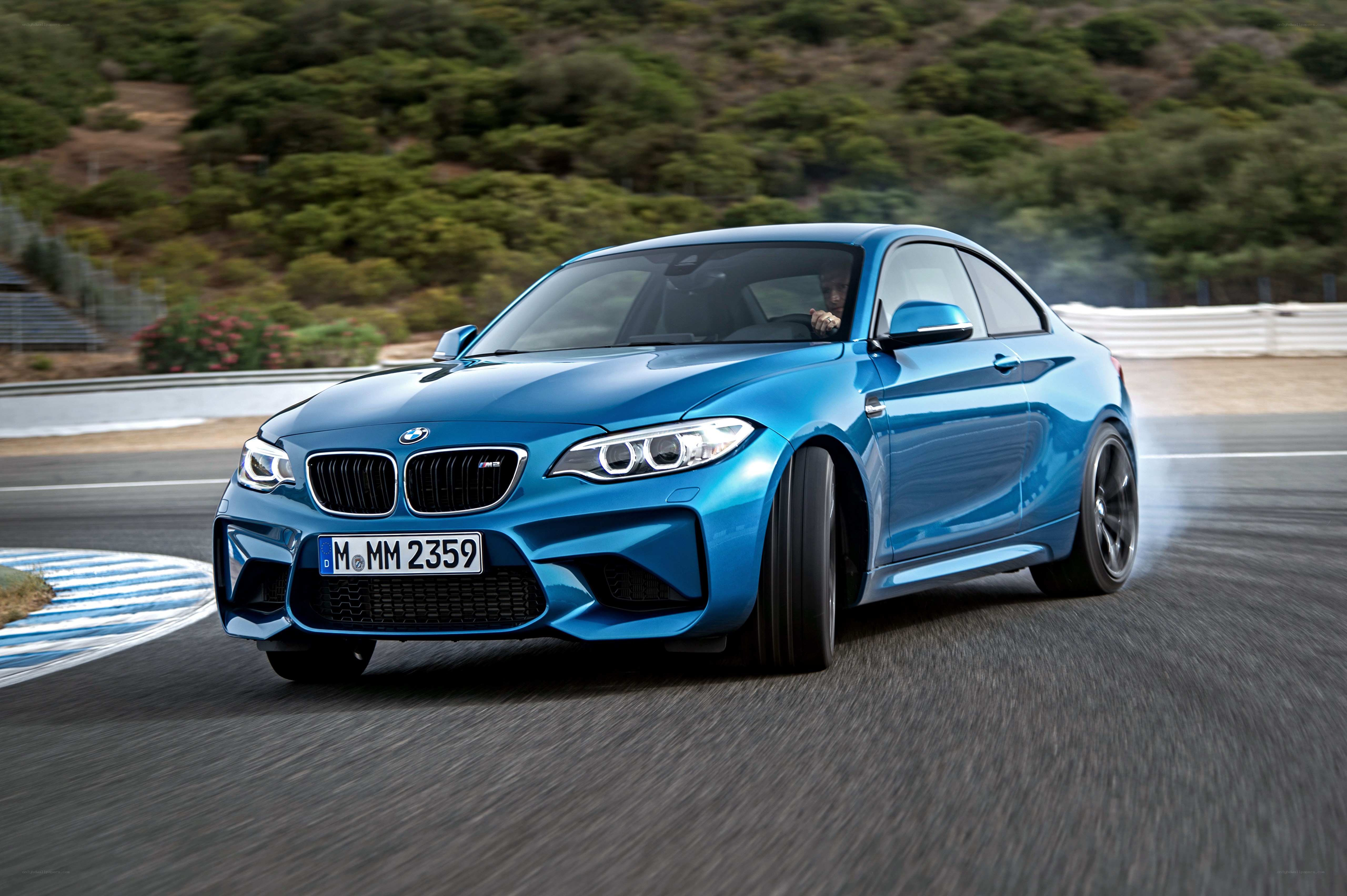 Blue BMW M2 on a racetrack