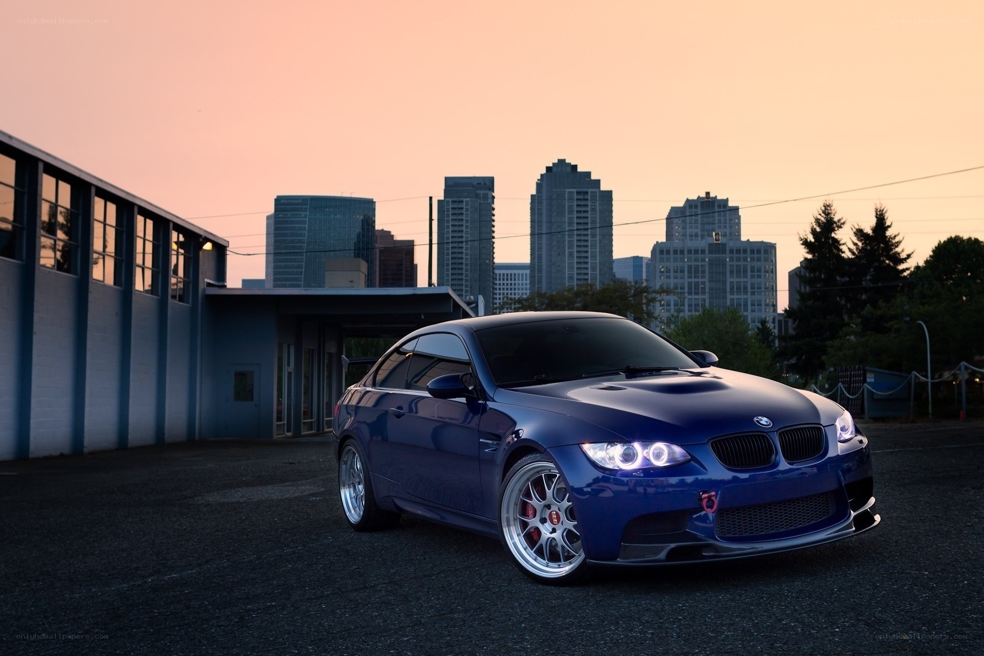 Blue BMW M3 at sunset