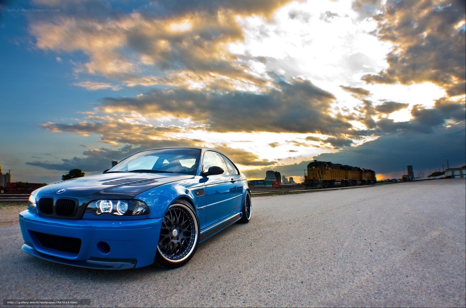 Blue BMW M3 at sunset