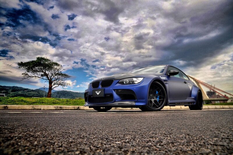 Blue BMW M3 on a scenic road