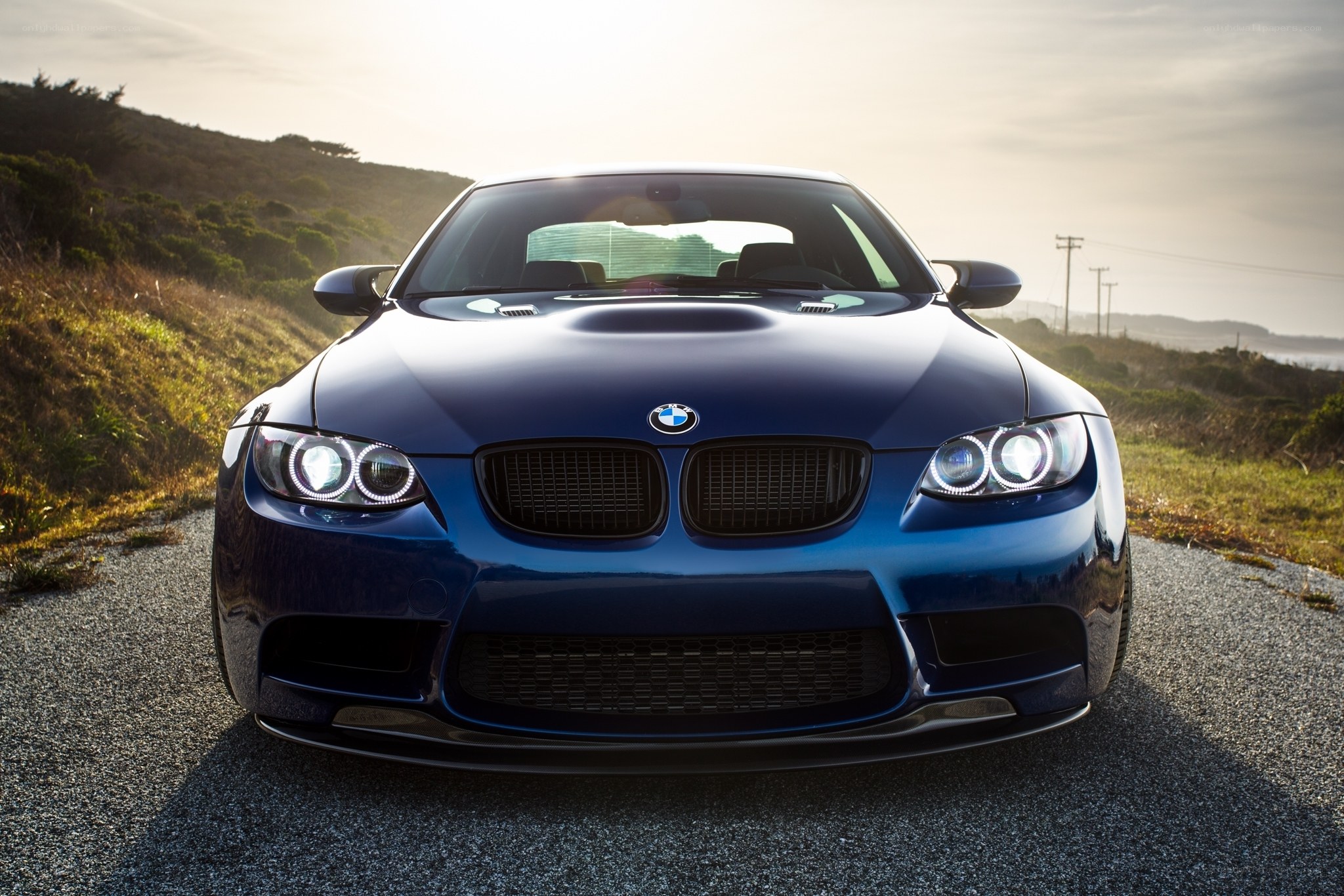 Blue BMW M3 on coastal road