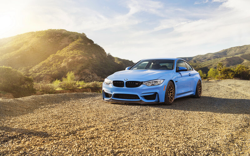 Blue BMW M4 on gravel road