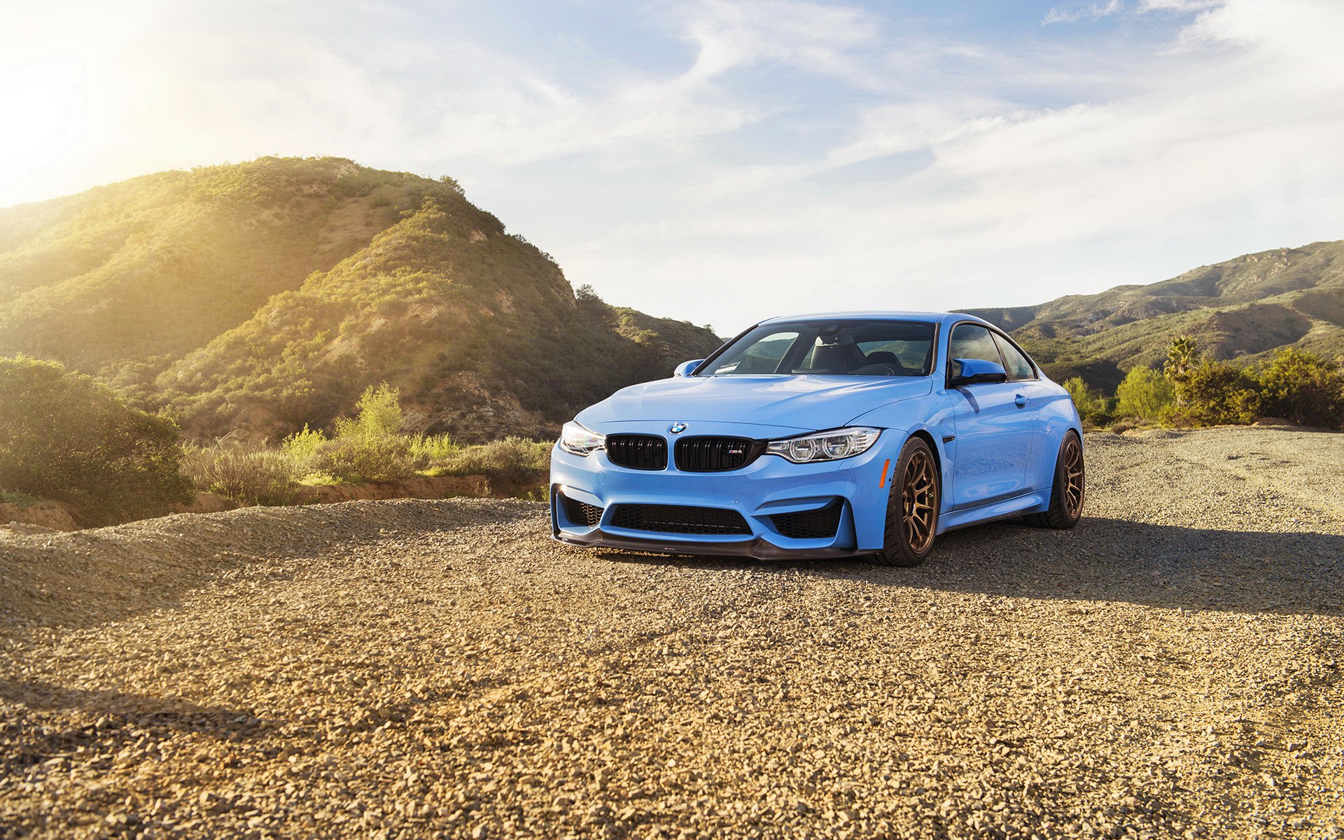 Blue BMW M4 on gravel road