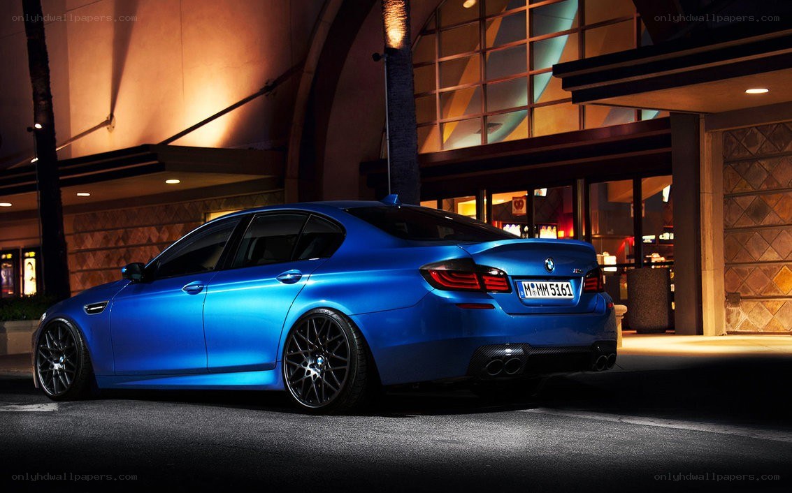 blue bmw m5 at night