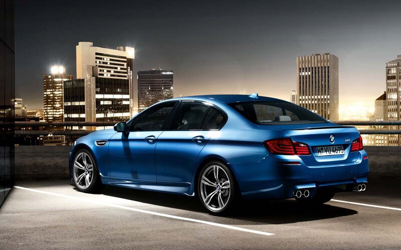 Blue BMW M5 at night