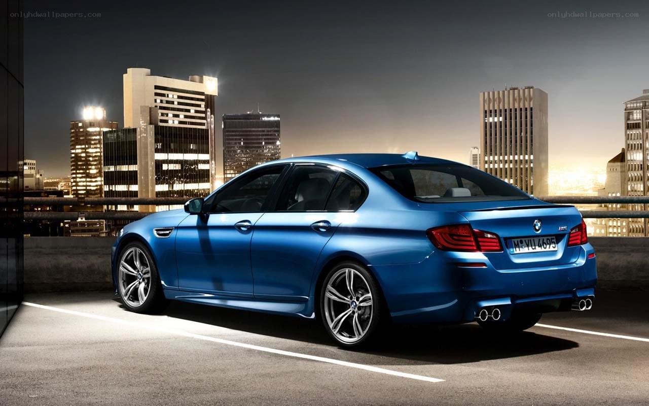 Blue BMW M5 at night