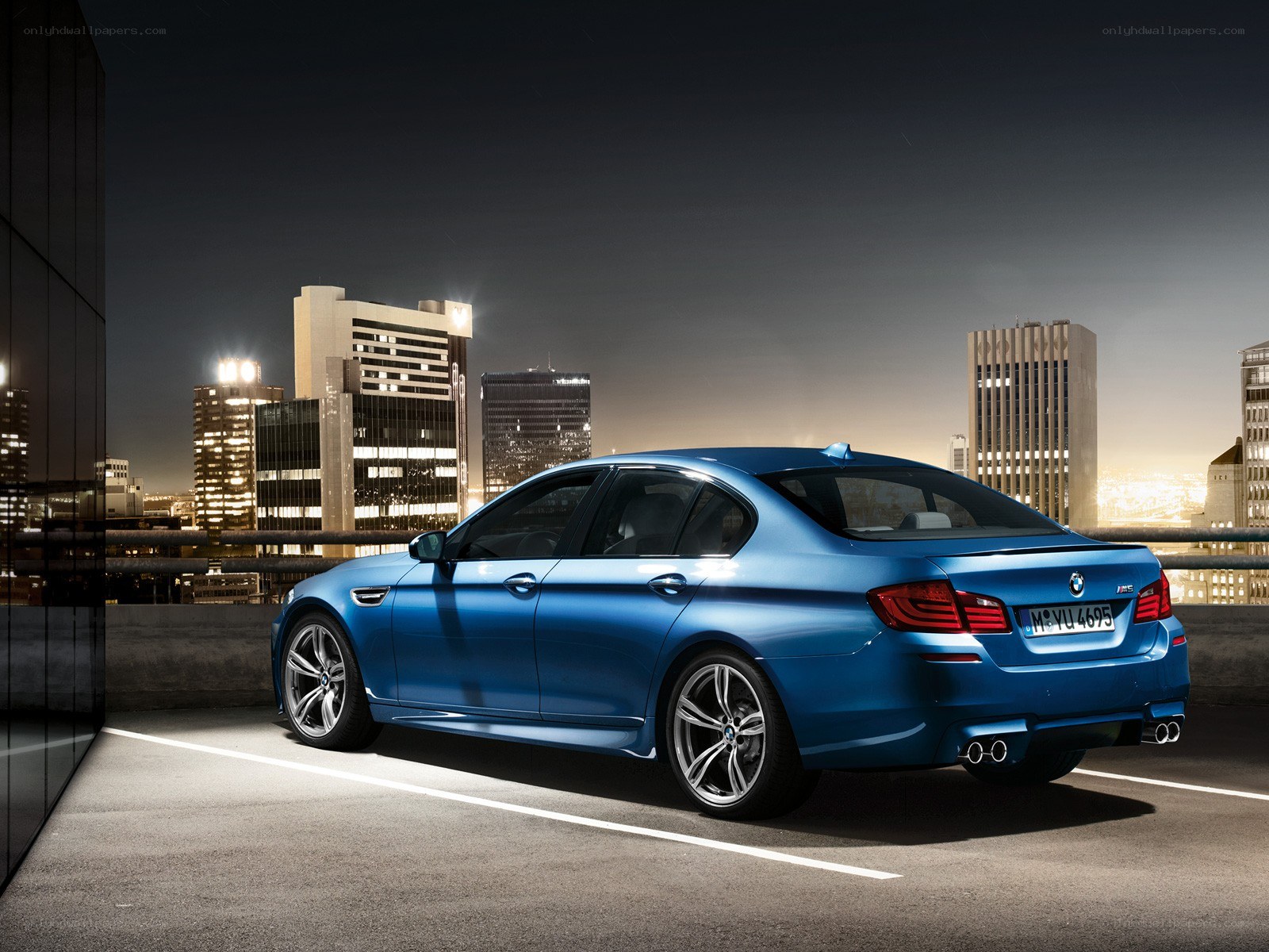 Blue BMW M5 at night