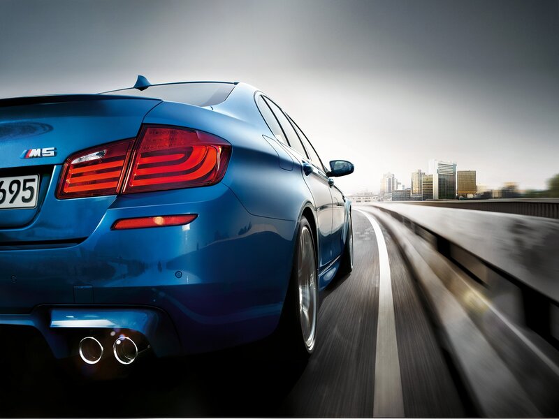 Blue BMW M5 Car — Dynamic, Afternoon, Photograph, Road, City Skyline