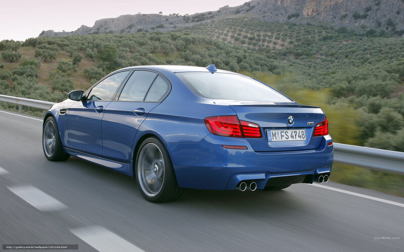 blue bmw m5 driving on road