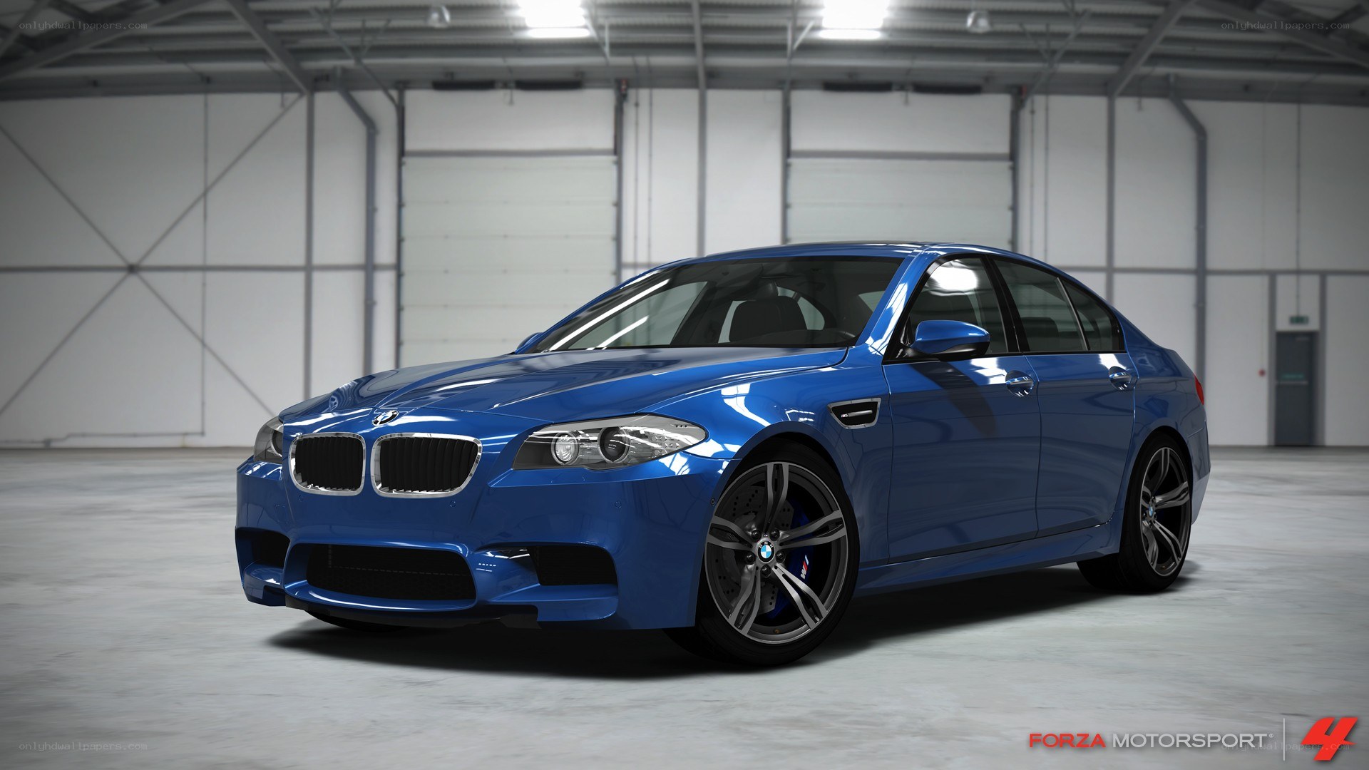 Blue BMW M5 in a warehouse