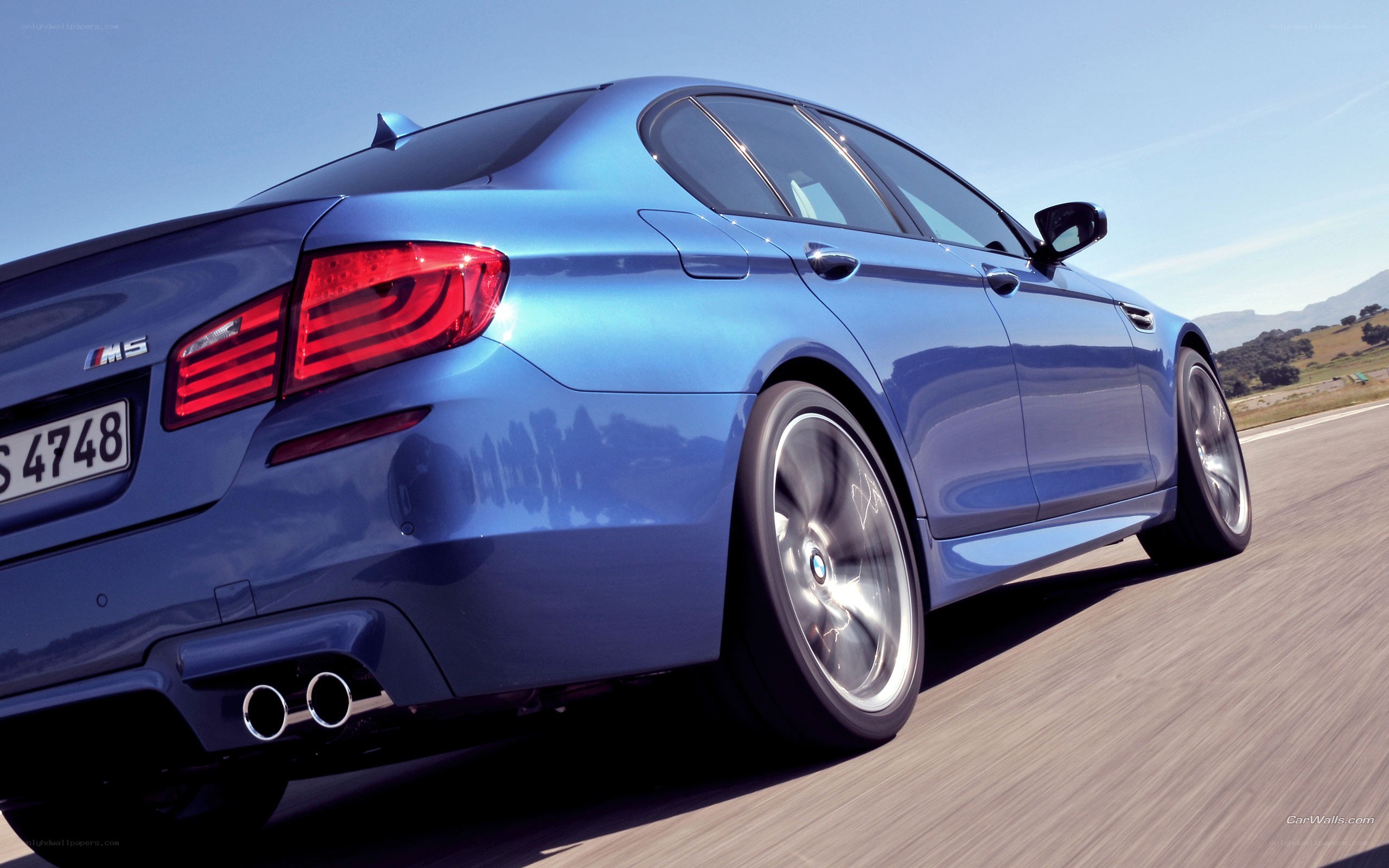 blue bmw m5 in motion