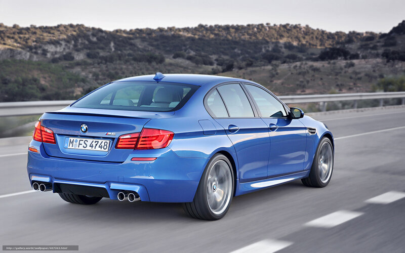 Blue BMW M5 on a highway