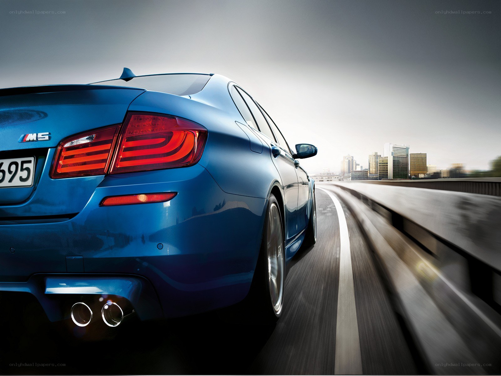 Blue BMW M5 on a highway