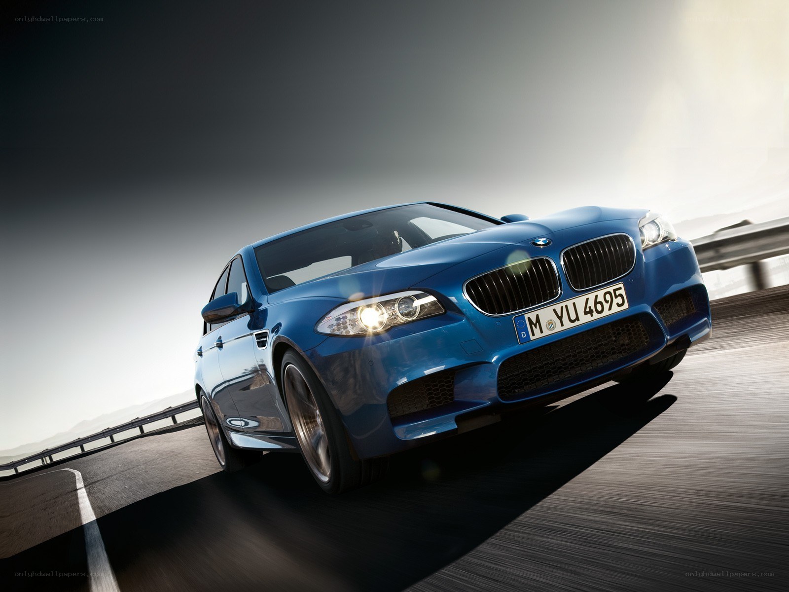 blue bmw m5 on a highway