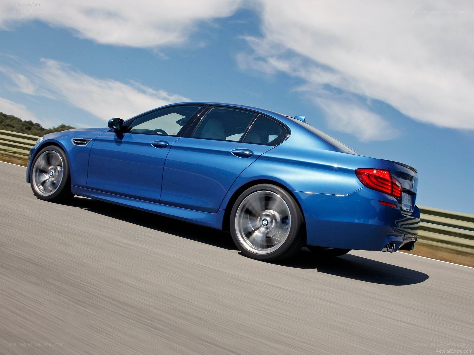 blue bmw m5 on a racetrack
