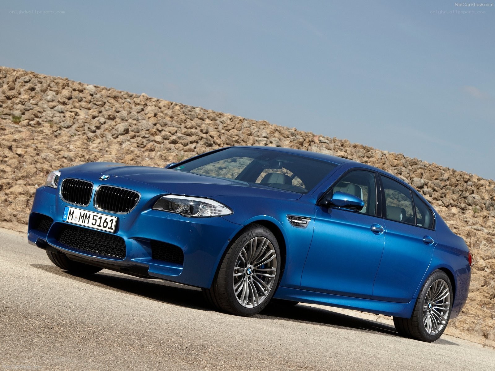 Blue BMW M5 on a road