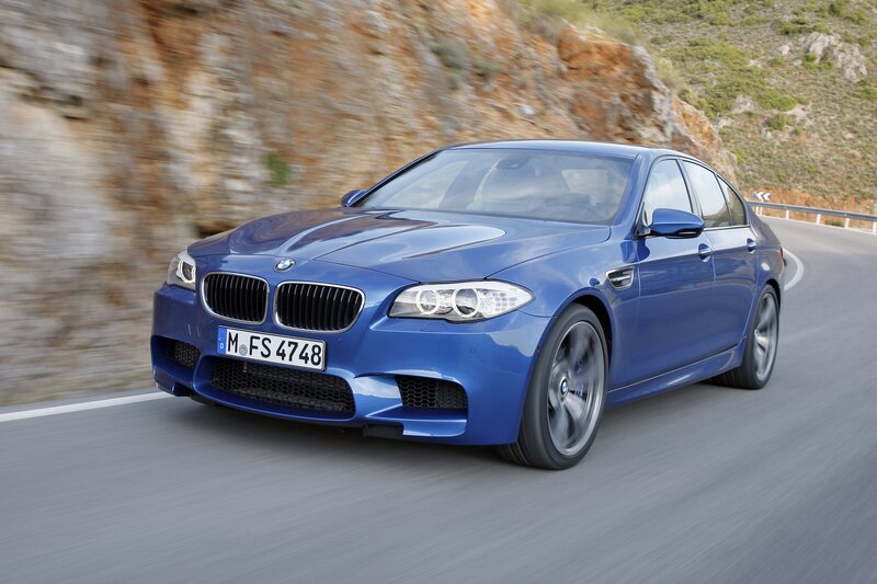 Blue BMW M5 on a winding road