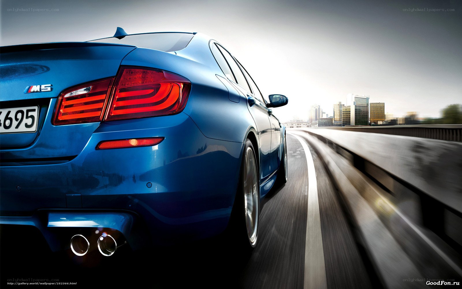 Blue BMW M5 on city highway