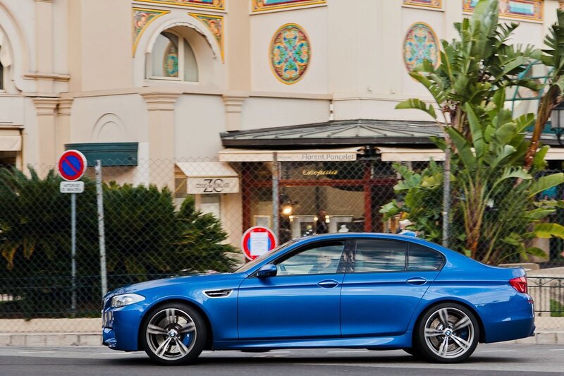 Blue BMW M5 on city street