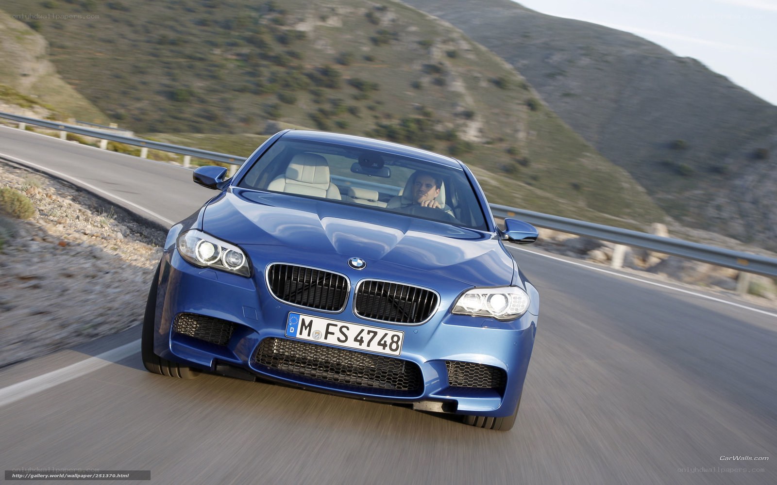 blue bmw m5 on mountain road