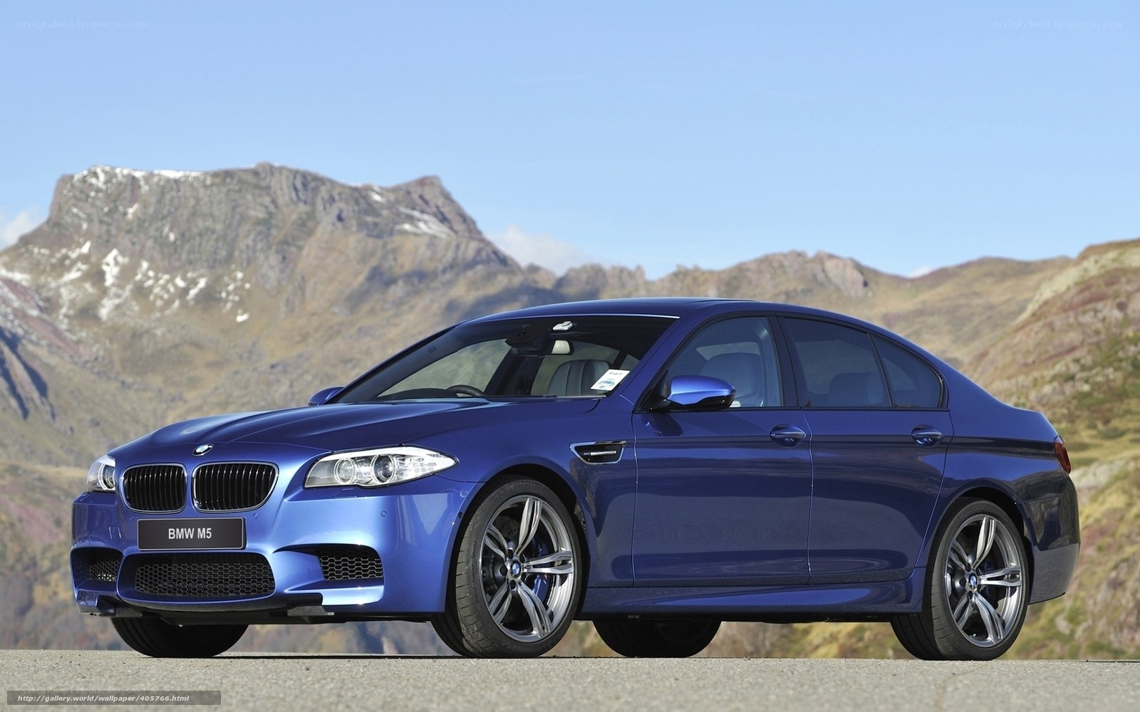 Blue BMW M5 on mountain road