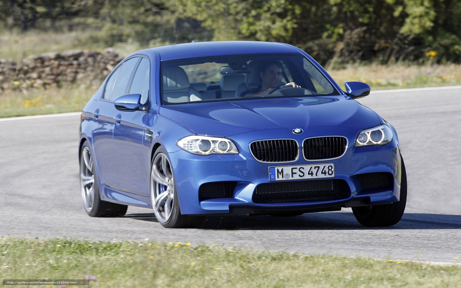 blue bmw m5 on road