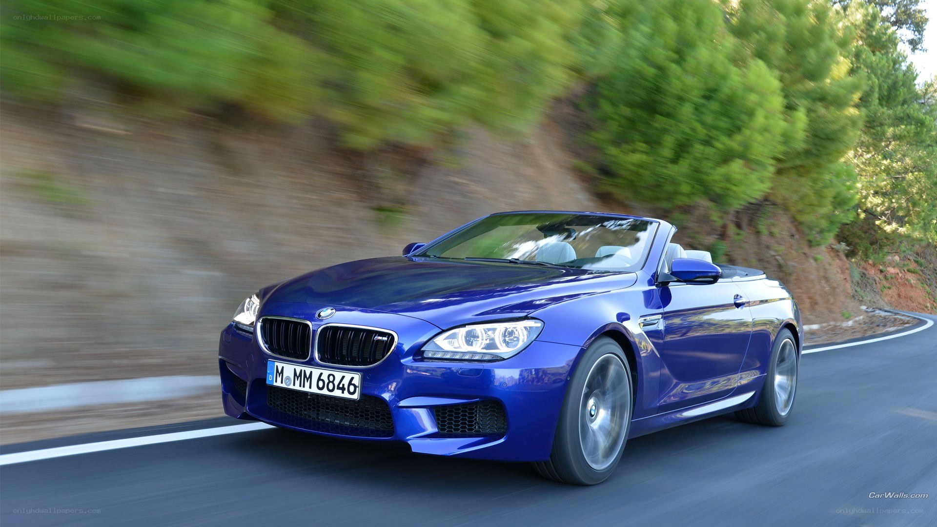 blue bmw m6 convertible driving
