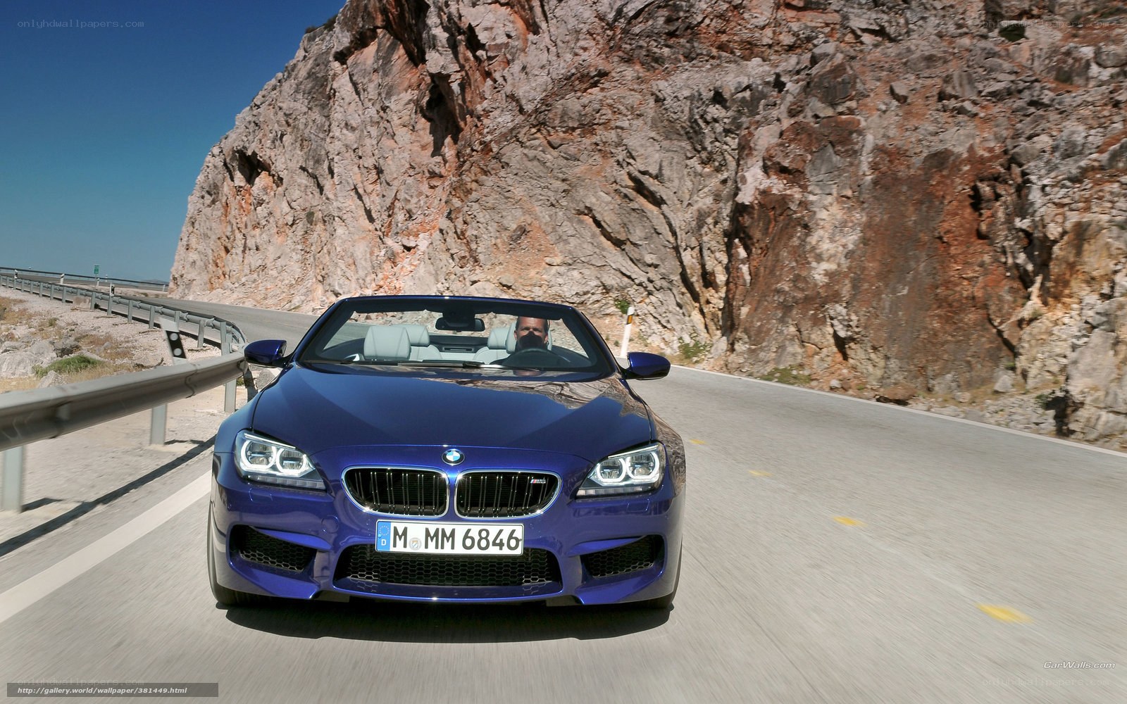Blue BMW M6 driving on mountain road