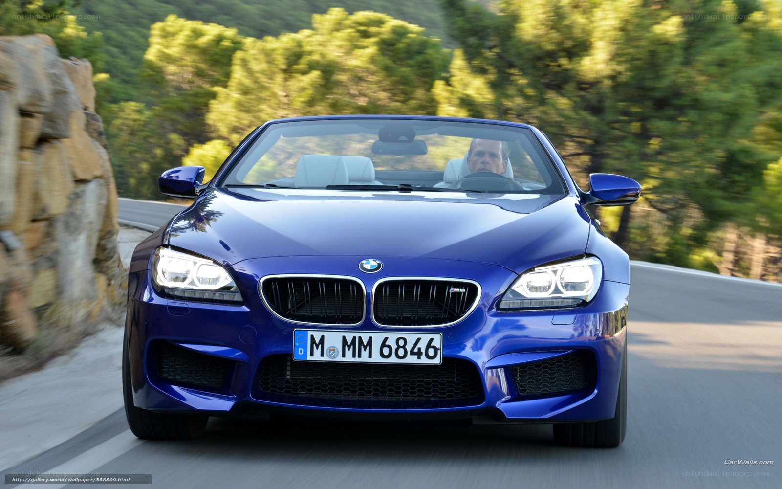 blue bmw m6 driving on road