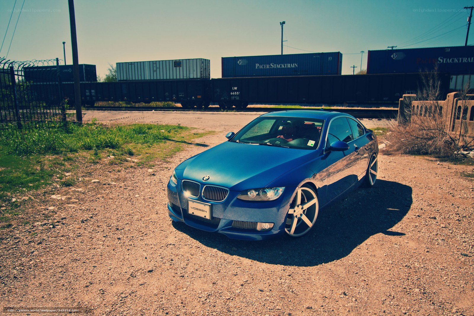 Blue BMW near train yard