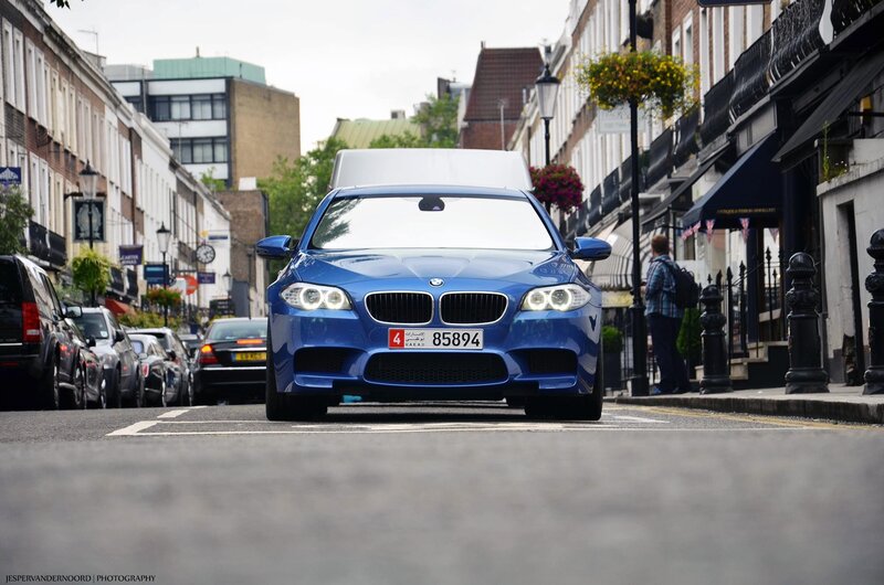 Blue BMW on a city street
