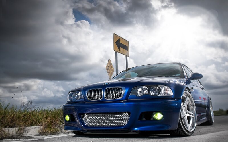 Blue BMW on a cloudy road