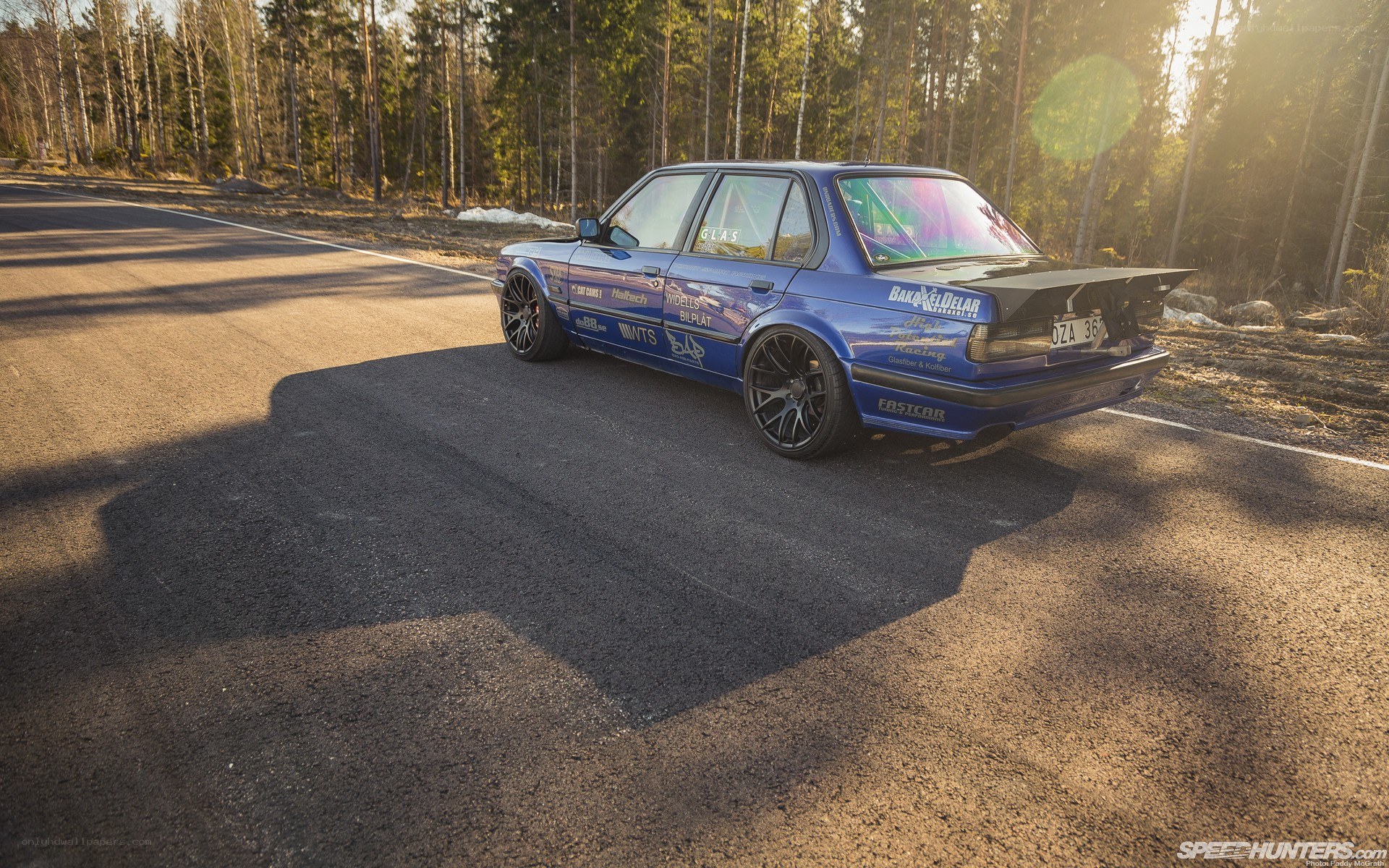 Blue BMW on a forest road