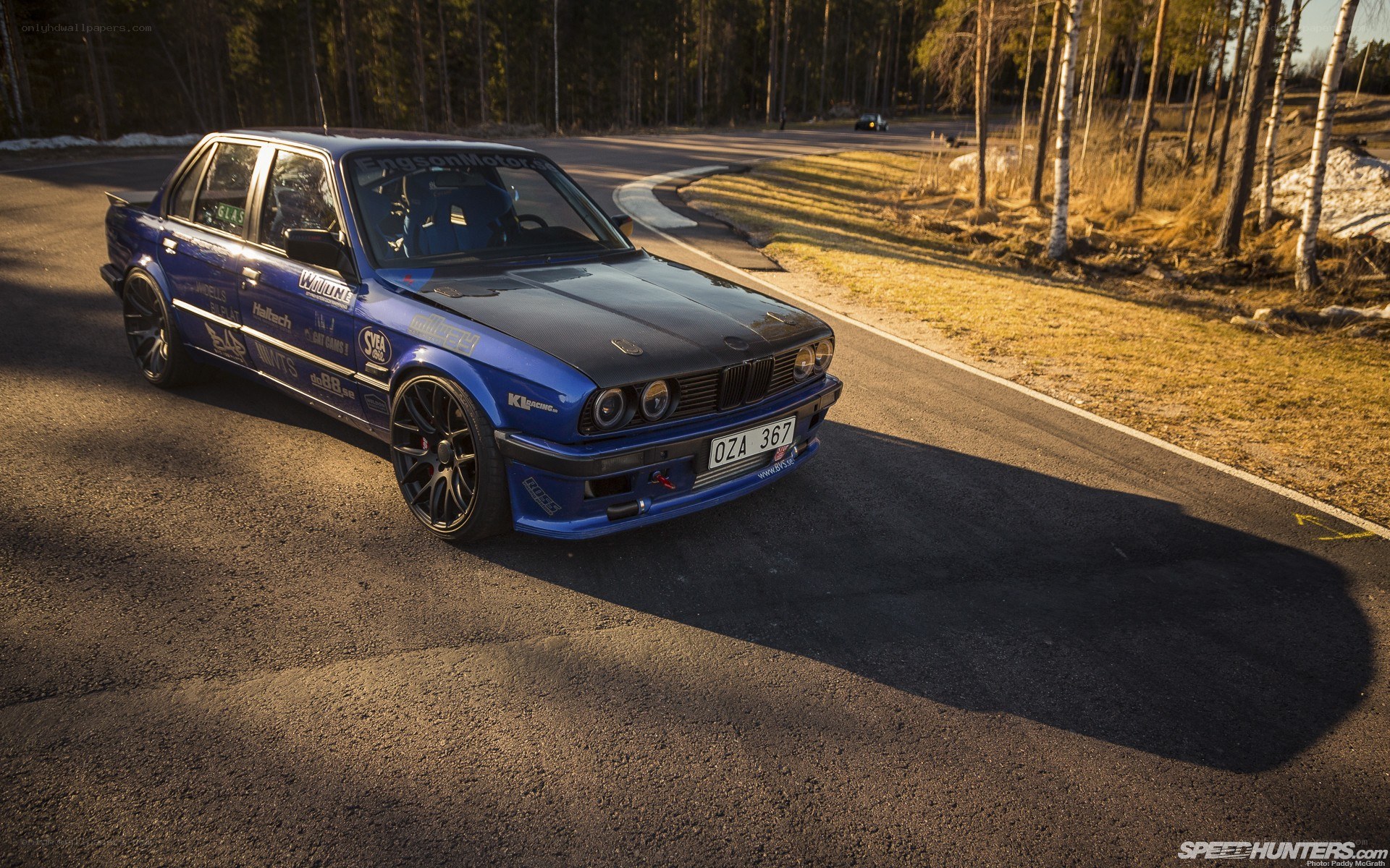 Blue BMW on a forest road